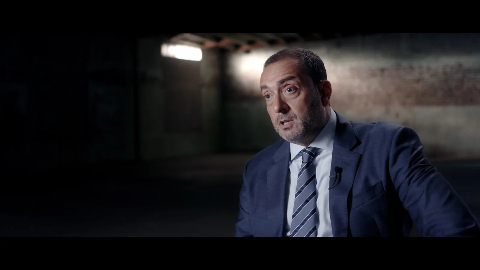 Detective Joe Kirby giving an interview about the investigation in the horror mockumentary Strange Harvest